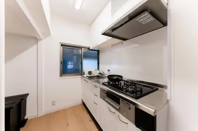 a kitchen with a stove top oven next to a window at SAKURA Residence\u76ee\u9ed2\u99c5\u524d Junior Suite in Tokyo