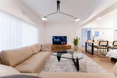 a living room with a couch and a table at SAKURA Residence\u76ee\u9ed2\u99c5\u524d Junior Suite in Tokyo