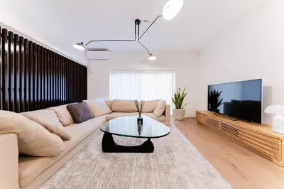 a living room with a couch and a coffee table at SAKURA Residence\u76ee\u9ed2\u99c5\u524d Junior Suite in Tokyo