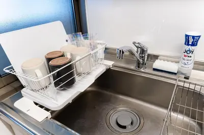 a kitchen sink with a dish drying rack next to it at SAKURA Residence\u76ee\u9ed2\u99c5\u524d Junior Suite in Tokyo