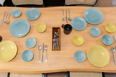a table with plates and utensils on it at SAKURA Residence\u76ee\u9ed2\u99c5\u524d Junior Suite in Tokyo