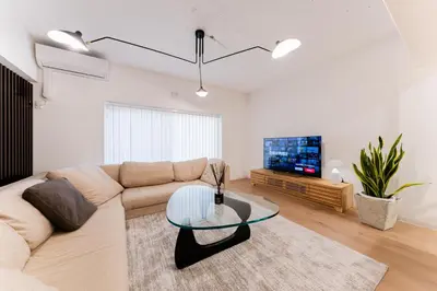 a living room with a couch and a glass table at SAKURA Residence\u76ee\u9ed2\u99c5\u524d Junior Suite in Tokyo