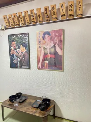 a table with two posters on a wall and a table with glasses at Shobi Building 2 208 - Vacation STAY 16685 in Tokyo
