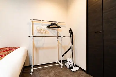 a room with a towel rack next to a bed at 84-5, Shiomi 301, Entire room for rent, \u6f6e\u898bB301 in Tokyo