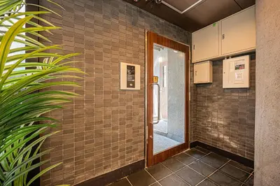a hallway with a door in a brick wall at Six7 Asakusa Ryogoku in Tokyo