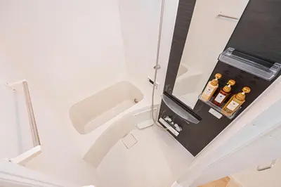a bathroom with a sink and a mirror at Six7 Asakusa Ryogoku in Tokyo