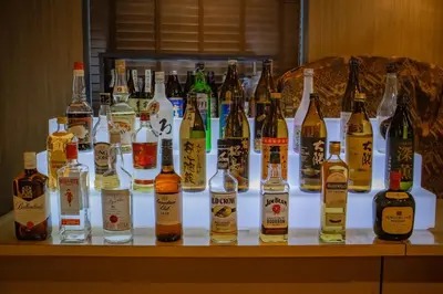 a group of bottles of alcohol on a table at Anshin oyado Tokyo Man Shinjuku in Tokyo