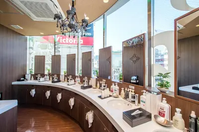 a bathroom with three sinks and a large mirror at Anshin oyado Tokyo Man Shinjuku in Tokyo