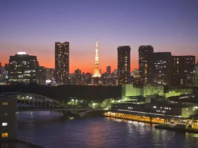 a city skyline at night with the eiffel tower at Anshin oyado Tokyo Man Akihabara in Tokyo