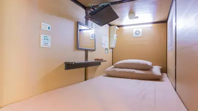 a small room with a bed and a sink at Anshin oyado Tokyo Man Akihabara in Tokyo