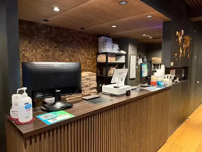 a store counter with a computer on top of it at Capsule Hotel Suzumoriya in Tokyo
