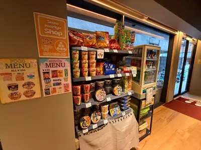 a store with a display of food on the wall at Capsule Hotel Suzumoriya in Tokyo