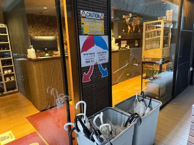 a shop window with a sign on the side of a store at Capsule Hotel Suzumoriya in Tokyo