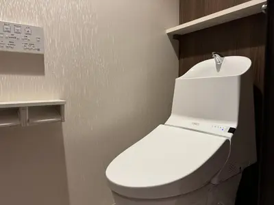 a bathroom with a white toilet in a room at Capsule Hotel Suzumoriya in Tokyo