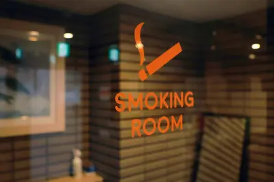 a smoking room sign on a wall in a kitchen at Hananoie\u83ef\u4e4b\u5bb6 in Tokyo