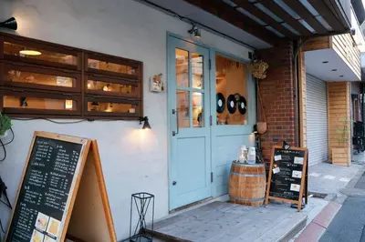 a store front with a blue door and a sign at Hananoie\u83ef\u4e4b\u5bb6 in Tokyo