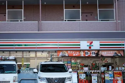 two white vans parked in front of a store at Hananoie\u83ef\u4e4b\u5bb6 in Tokyo