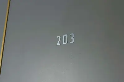 a sign with the number on a door at Hananoie\u83ef\u4e4b\u5bb6 in Tokyo