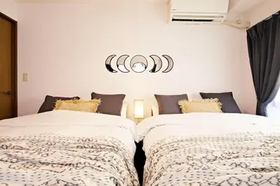 two beds sitting next to each other in a bedroom at NH Buil 7F in Tokyo