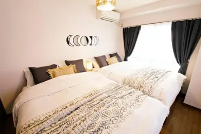 two beds sitting next to each other in a bedroom at NH Buil 7F in Tokyo