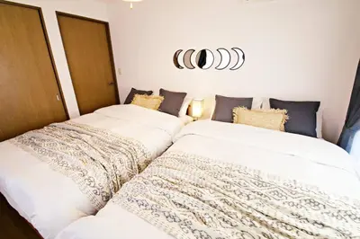 two beds sitting next to each other in a bedroom at NH Buil 7F in Tokyo