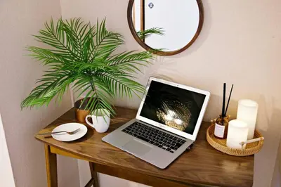a laptop computer sitting on top of a wooden table at NH Buil 7F in Tokyo