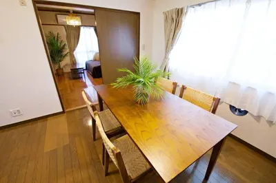 a dining room with a wooden table and chairs at NH Buil 7F in Tokyo