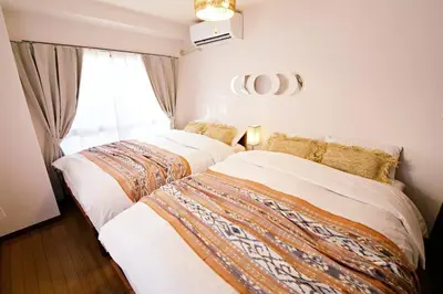 two beds sitting next to each other in a bedroom at NH Buil 7F in Tokyo