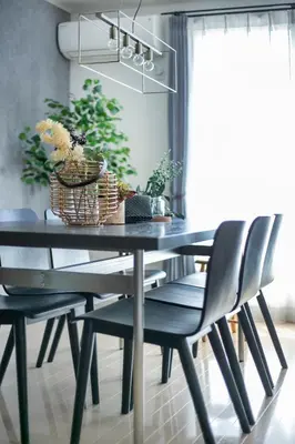 a black dining room table with two chairs and plants at \u3077\u3075\u304b\u5927\u5cf6 in Tokyo
