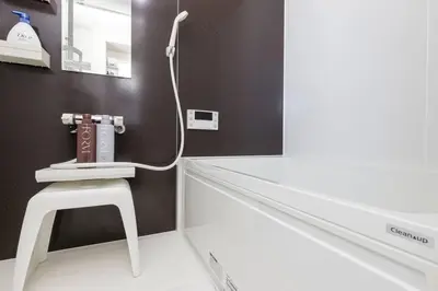 a bathroom with a hair dryer on the wall at \u30db\u30b9\u30c6\u30eb\u30a2\u30df\u30fc\u30c1 Hostel Amici in Tokyo