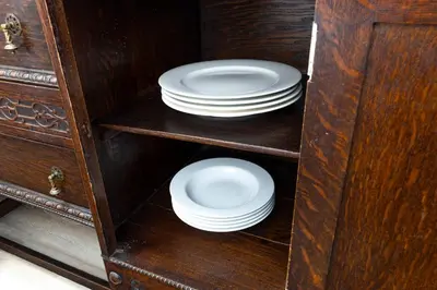 a wooden cabinet with white plates in it at \u30db\u30b9\u30c6\u30eb\u30a2\u30df\u30fc\u30c1 Hostel Amici in Tokyo