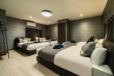 a hotel room with three beds and a couch at 90, Yotsugi-A, private house rental, \u30ef\u30f3\u30d3\u30ec\u30c3\u30b8\u56db\u3064\u6728 in Tokyo