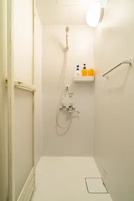 a white bathroom with a shower and a sink at 90, Yotsugi-A, private house rental, \u30ef\u30f3\u30d3\u30ec\u30c3\u30b8\u56db\u3064\u6728 in Tokyo