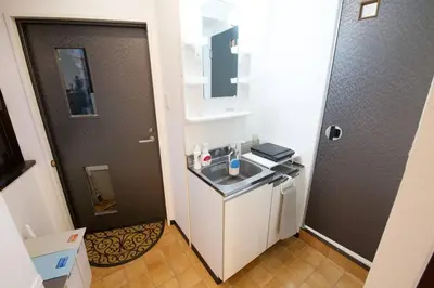 a small kitchen with a sink and a refrigerator at \u30ea\u30de\u30fc\u30eb\u30d3\u30eb2 401 in Tokyo