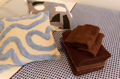 a pile of towels sitting on top of a table at G-Stage 01 IKEBUKURO by Tranova in Tokyo