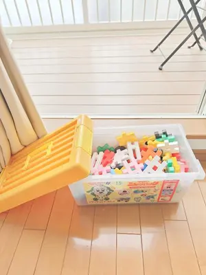 a plastic container full of toys sitting on a floor at SunshineHouse \u5411\u5cf6 in Tokyo