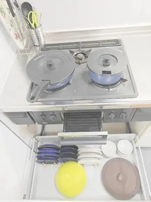 a drawer in a refrigerator filled with pans and utensils at SunshineHouse \u5411\u5cf6 in Tokyo