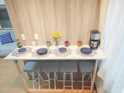 a table with four blue plates and a coffee maker at SunshineHouse \u5411\u5cf6 in Tokyo