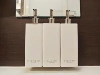 a trio of white towels sitting on top of a counter at MEZON DE OAK Shin-Okubo in Tokyo