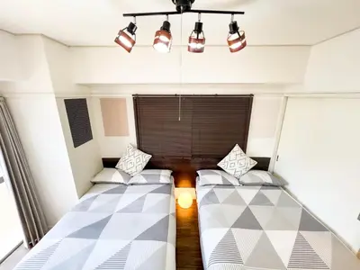 a small room with two beds and a window at Kuramae HK 501 in Tokyo