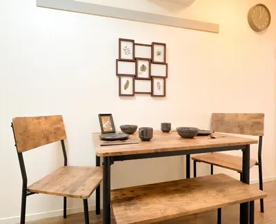 a wooden table with two chairs and bowls on it at Kuramae HK 501 in Tokyo