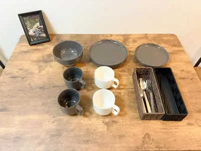 a group of bowls and cups on a wooden table at Kuramae HK 501 in Tokyo
