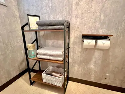 a towel rack with towels and towels in a bathroom at Kuramae HK 501 in Tokyo