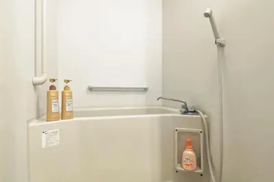 a bathroom with a white refrigerator with two bottles on it at Konoha House - Vacation STAY 11581v in Tokyo