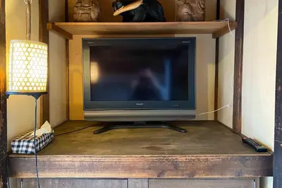 a television sitting on a wooden entertainment center at Konoha House - Vacation STAY 11581v in Tokyo