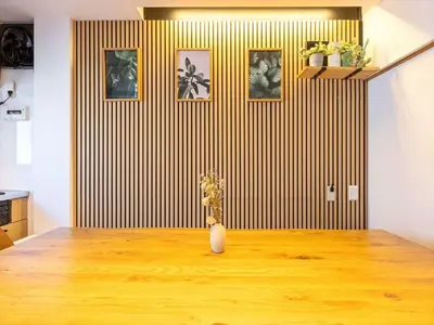 a vase with flowers on a wooden table in a room at Eden House - Vacation STAY 16713 in Tokyo