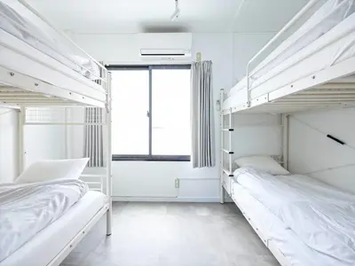 two bunk beds in a white room with a window at Eden House - Vacation STAY 16713 in Tokyo