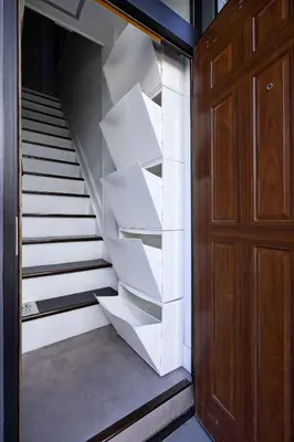 a staircase with white shelves next to a wooden door at Eden House - Vacation STAY 16713 in Tokyo
