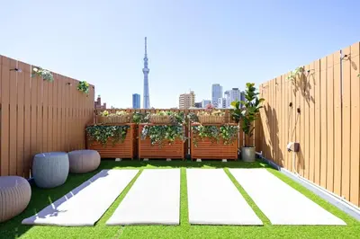 a small backyard with a fence and grass at Eden House - Vacation STAY 16713 in Tokyo