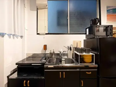 a kitchen with a sink and a refrigerator at Eden House - Vacation STAY 16712 in Tokyo
